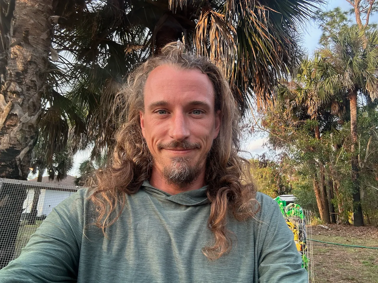 Andy Brazil, founder of CauseTrail, outdoors among palm trees
